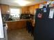 Small kitchen with wood cabinets, tile floor, and standard appliances at 1434 Butler St, Jonesboro, GA 30236