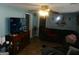 Living room featuring a sofa, TV, and wood cabinet at 1434 Butler St, Jonesboro, GA 30236