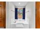 Relaxing bathroom with soaking tub and view of the backyard at 206 Sandown Dr, Peachtree City, GA 30269