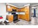 Kitchen boasts wood cabinets, stainless steel appliances, and vinyl flooring at 206 Sandown Dr, Peachtree City, GA 30269