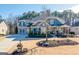 Two-story craftsman style home with gray siding, stone accents, and a three-car garage at 4960 Shade Creek Xing, Cumming, GA 30028