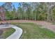 Landscaped backyard with a patio and wooded area at 125 Fawn Brook Pass, Fayetteville, GA 30215