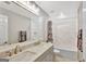 Modern bathroom with double vanity, marble tile, and bathtub at 125 Fawn Brook Pass, Fayetteville, GA 30215