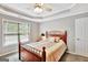 Charming bedroom with a wooden bed frame and a large window at 125 Fawn Brook Pass, Fayetteville, GA 30215