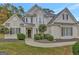 Two-story house with beige exterior, landscaping, and a walkway at 125 Fawn Brook Pass, Fayetteville, GA 30215