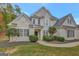 Two-story house with beige exterior, landscaping, and a walkway at 125 Fawn Brook Pass, Fayetteville, GA 30215