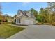 Three-car garage with driveway and landscaping at 125 Fawn Brook Pass, Fayetteville, GA 30215