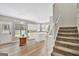 Modern kitchen with white cabinets and an island, plus stairs at 125 Fawn Brook Pass, Fayetteville, GA 30215