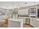 Modern kitchen with white cabinets, stainless steel appliances and island at 125 Fawn Brook Pass, Fayetteville, GA 30215