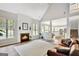 Open concept living room with a fireplace, high ceilings and hardwood floors at 125 Fawn Brook Pass, Fayetteville, GA 30215