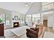 Open concept living room with a fireplace, high ceilings and hardwood floors at 125 Fawn Brook Pass, Fayetteville, GA 30215