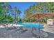 Community swimming pool with lounge chairs and umbrellas at 125 Fawn Brook Pass, Fayetteville, GA 30215