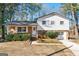 Ranch style home with brick and white siding, a carport and well-manicured lawn at 1586 Dellwood Cir, Lake City, GA 30260