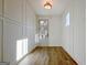 Bright entryway with wood floors and white wainscoting at 3165 Old Jonesboro Rd, Hapeville, GA 30354