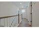 Upstairs hallway with wood floors and white walls at 3165 Old Jonesboro Rd, Hapeville, GA 30354