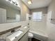 Updated bathroom with granite countertop, white tile, and bathtub at 2959 Fairburn Rd, Atlanta, GA 30331