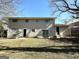 Back exterior view showing a ranch home with sliding glass doors and a yard at 2959 Fairburn Rd, Atlanta, GA 30331