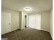 Bright bedroom with carpet flooring, a door and sliding glass doors leading to the outside at 1618 Old Alabama Rd, Austell, GA 30168
