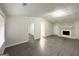 Bright living room featuring gray flooring and a stone fireplace at 1618 Old Alabama Rd, Austell, GA 30168