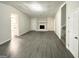 Spacious living room with gray flooring and a stone fireplace at 1618 Old Alabama Rd, Austell, GA 30168