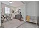Finished basement area with small table, chairs, and crib at 32 American Walk, Peachtree City, GA 30269