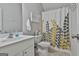 Clean bathroom with white vanity, shower, and patterned curtain at 32 American Walk, Peachtree City, GA 30269