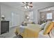 Bedroom with yellow bedding and sitting area at 32 American Walk, Peachtree City, GA 30269
