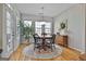 Bright breakfast area with hardwood floors, a round table, and access to a deck at 32 American Walk, Peachtree City, GA 30269