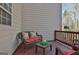 Cozy deck with wicker furniture and red cushions at 32 American Walk, Peachtree City, GA 30269