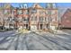 Brick townhouses with attached garages and landscaping at 32 American Walk, Peachtree City, GA 30269
