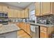Modern kitchen with granite countertops and stainless steel appliances at 32 American Walk, Peachtree City, GA 30269