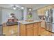 Large kitchen island with granite top, seating and ample storage at 32 American Walk, Peachtree City, GA 30269