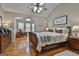 Spacious main bedroom with hardwood floors, a ceiling fan, and access to a sunroom at 32 American Walk, Peachtree City, GA 30269