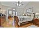Spacious main bedroom with hardwood floors, a ceiling fan, and access to a sunroom at 32 American Walk, Peachtree City, GA 30269