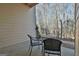 Small patio with wooded view, table, and chairs at 32 American Walk, Peachtree City, GA 30269