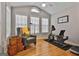 Sunroom with hardwood floors, large windows, and exercise equipment at 32 American Walk, Peachtree City, GA 30269