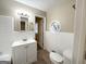 Clean bathroom with white tiled walls, a pedestal sink, and a bathtub at 3138 Beechwood Dr, Lithia Springs, GA 30122