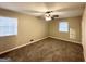 Bright bedroom featuring carpet flooring and two windows at 3138 Beechwood Dr, Lithia Springs, GA 30122