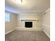 Finished basement with brick fireplace and neutral carpet at 3621 W County Line Rd, Douglasville, GA 30135