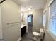 Updated bathroom with dark gray floor tiles, toilet, vanity, and shower at 121 Pine Forest Dr, Dallas, GA 30157