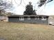 Gray house exterior with a spacious yard and mature trees at 121 Pine Forest Dr, Dallas, GA 30157