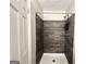 Clean shower with gray tile surround and shower caddy at 121 Pine Forest Dr, Dallas, GA 30157