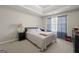 Cozy bedroom features a tray ceiling, plush carpet, and a sunlit window with stylish curtains at 319 Allegrini Dr, Atlanta, GA 30349