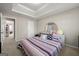 Cozy bedroom featuring a striped bedspread, carpet, and a round decorative mirror at 319 Allegrini Dr, Atlanta, GA 30349