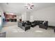 Open-concept living room with a black leather sofa, light carpet, and view into the kitchen at 319 Allegrini Dr, Atlanta, GA 30349