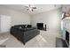 Cozy living room with plush carpet, a modern fireplace, and a comfortable black leather sofa at 319 Allegrini Dr, Atlanta, GA 30349