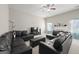 Bright living room with a large black leather sectional sofa, plush carpet, and a fireplace at 319 Allegrini Dr, Atlanta, GA 30349