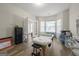 Well-lit room with wood floors, featuring massage table and potential for customized use at 319 Allegrini Dr, Atlanta, GA 30349