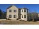 Two-story home with brick and gray siding, and landscaping at 352 Traditions Ln, Hampton, GA 30228