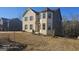 Two-story home with brick and gray siding, and landscaping at 352 Traditions Ln, Hampton, GA 30228